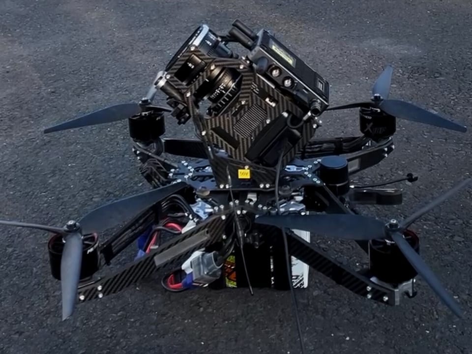 FPV camera aircraft with a cinema camera on the runway, aerobatic aircraft behind
